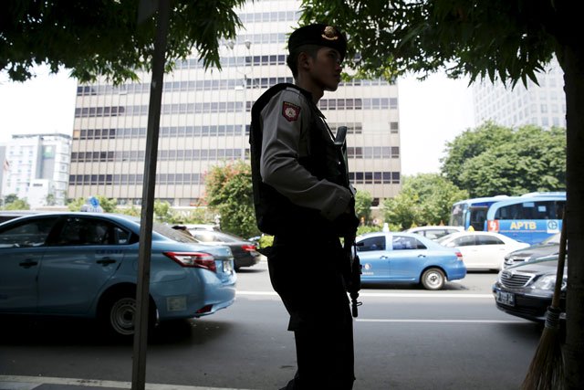 an indonesian policeman holds a rifle as he patrols near a bomb blast site at the thamrin business district in jakarta on january 15 2016 photo reuters