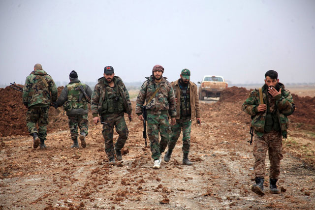 syrian regime forces walk in an area south of the town of al bab in the northern province of aleppo on january 14 2016 photo afp