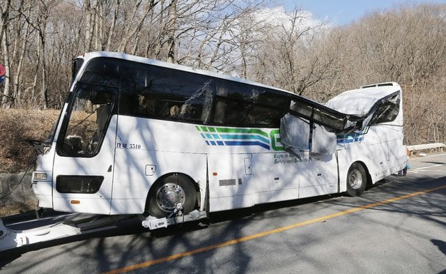 a crashed bus is pulled by a tow truck in karuizawa in nagano prefecture central japan on january 15 2016 after it ran off a mountain road photo afp a crashed bus is pulled by a tow truck in karuizawa in nagano prefecture central japan on january 15 2016 after it ran off a mountain road photo afp