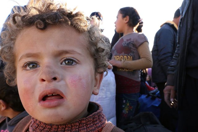 syrian refugees stuck between the jordanian and syrian borders wait to cross into jordan near the town of ruwaished east of the jordanian capital amman january 14 2016 photo afp