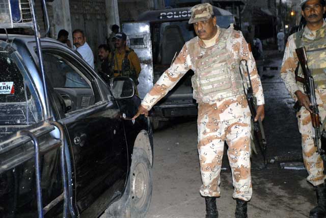 a rangers official inspecting the vehicle which was affected by the grenade attack in lyari on january 15 2016 photo mohammad noman