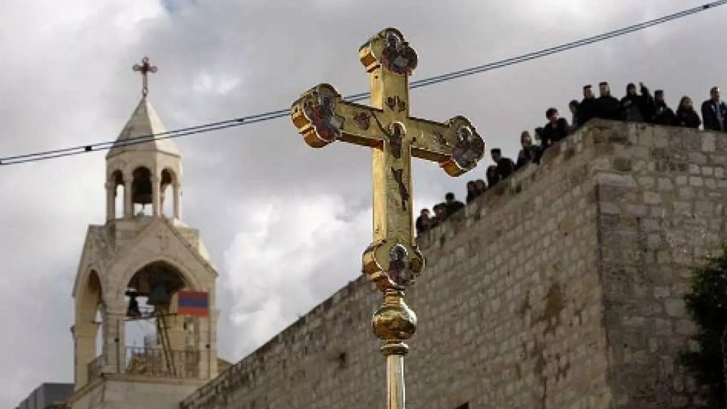 a crucifix is held up in front of the church of the nativity during the orthodox christmas procession in the west bank town of bethlehem january 6 2011 photo reuters a crucifix is held up in front of the church of the nativity during the orthodox christmas procession in the west bank town of bethlehem january 6 2011 photo reuters