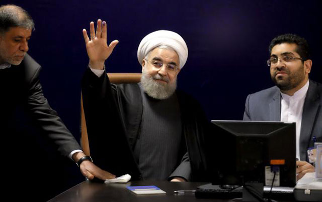 iranian president hassan rouhani c waves after he registered for february 039 s election of the assembly of experts the clerical body that chooses the supreme leader at the interior ministry in tehran on december 21 2015 photo reuters