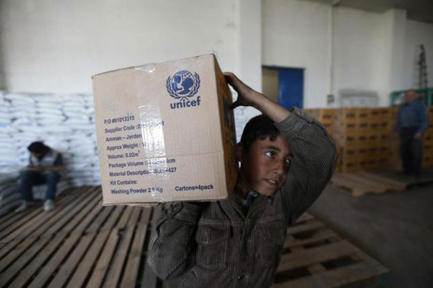 a boy receives humanitarian aid in duma damascus march 29 2014 photo reuters