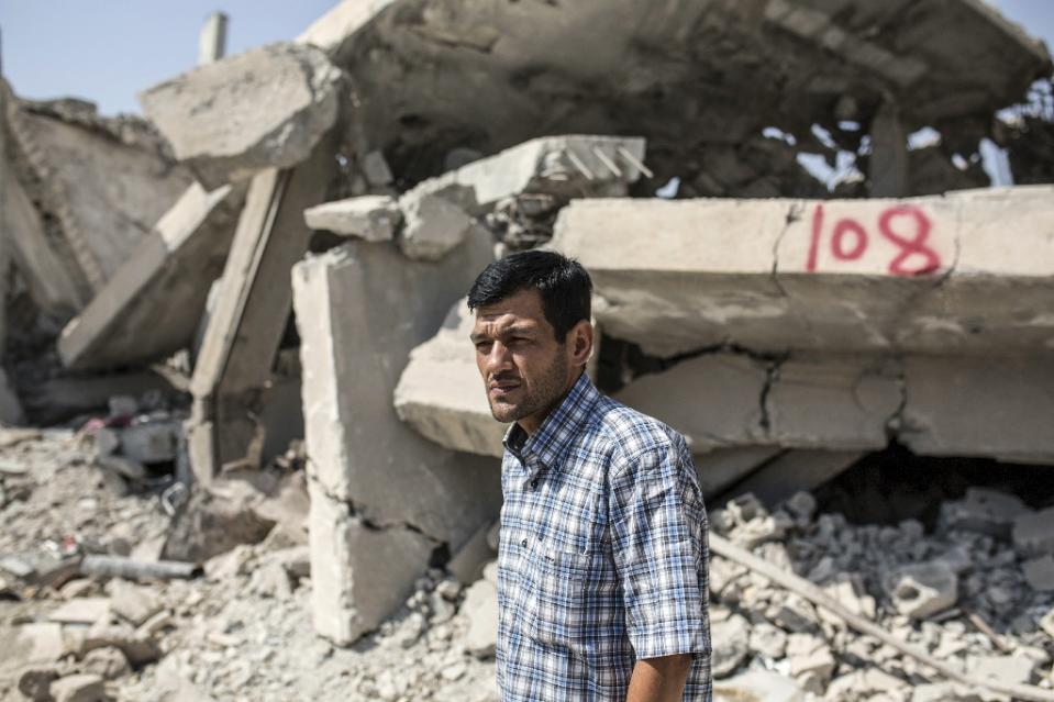 abdullah kurdi father of three year old aylan kurdi who drowned off turkey stands in front of his neighbour 039 s house on september 6 2015 in kobane photo afp