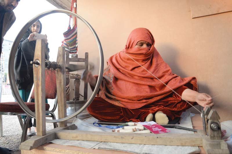 a woman displays her stalls at hunar mela photo muhammad iqbal express