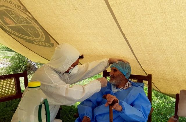 a paramedic wearing protective gear takes a nasal swab of 103 year old abdul alim to be tested for the coronavirus disease covid 19 at the aga khan health services emergency response centre in booni chitral photo reuters a paramedic wearing protective gear takes a nasal swab of 103 year old abdul alim to be tested for the coronavirus disease covid 19 at the aga khan health services emergency response centre in booni chitral photo reuters