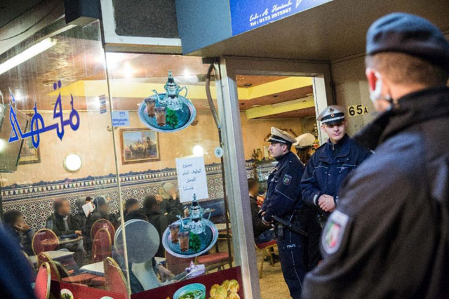 policemen stand in front of a cafe in the so called maghreb district of duesseldorf western germany during a raid on january 16 2016 photo afp