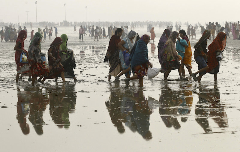 hindu pilgrims walk back after taking a dip at the confluence of the ganges river and the bay of bengal at sagar island south of kolkata india on january 14 2016 photo reuters