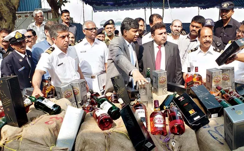officials presenting liquor bottles that were seized by model collectorate of customs when they were being smuggled into the city photo online officials presenting liquor bottles that were seized by model collectorate of customs when they were being smuggled into the city photo online