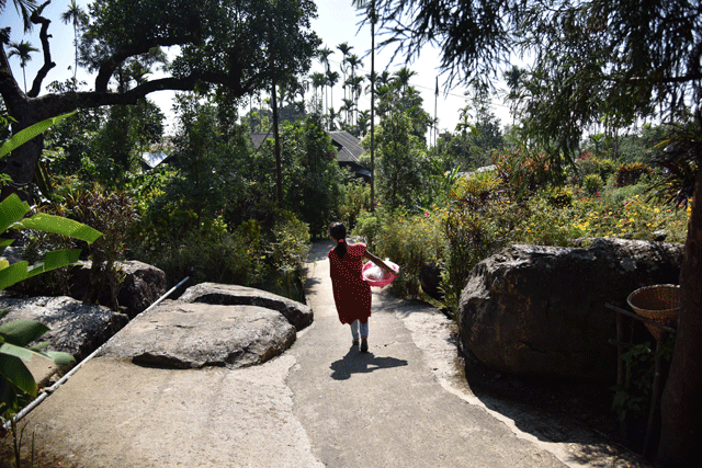 to go with india tourism leisure lifestyle focus by etienne fontaine in this photograph taken on november 8 2015 an indian khasi tribal villager walks along a lane in the village of mawlynnong in the north eastern state of meghalaya in the tiny hamlet of mawlynnong in india 039 s far north east plastic is banned and spotless paths are lined with flowers    but its reputation as asia 039 s cleanest village has proved a mixed blessing photo afp