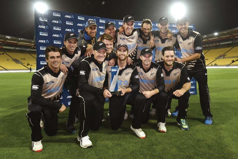 new zealand players pose with the anz t20 trophy after their collective effort allowed them to condemn pakistan to a humiliating defeat in the decider photo afp