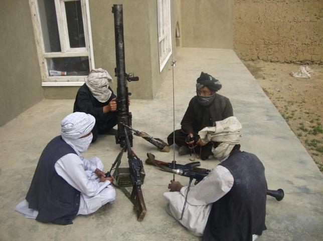 taliban fighters pose with weapons as they sit in their compound at an undisclosed location in southern afghanistan in this may 5 2011 file picture photo reuters