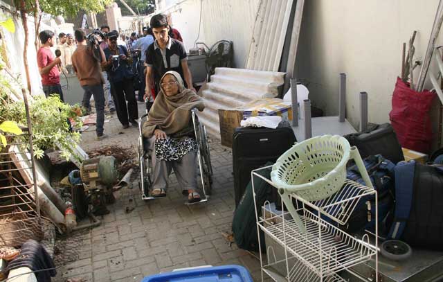 residents seen outside their home after authorities started demolishing their houses inside sindh assembly premises photo mohammad saqib