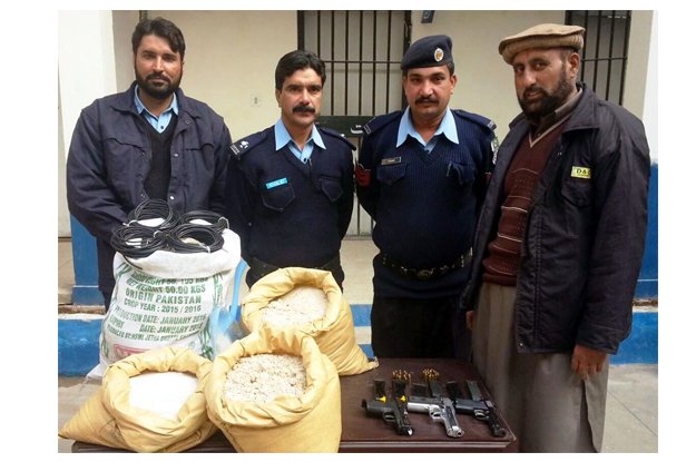 police officials displaying the seized weapons photo inp