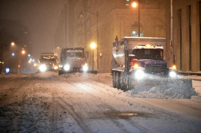 snow plows clean the snow from a street in downtown washington dc on january 22 2016 photo afp snow plows clean the snow from a street in downtown washington dc on january 22 2016 photo afp