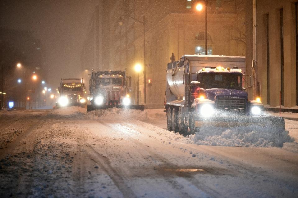 snow plows clean the snow from a street in downtown washington dc on january 22 2016 photo afp