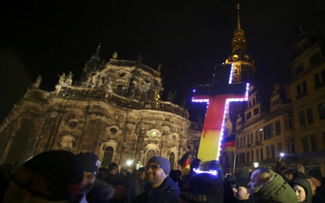 file photo of participants holding a cross painted in the colours of german national flag during a demonstration called by anti immigration group pegida a german abbreviation for 039 patriotic europeans against the islamisation of the west 039 in dresden december 22 2014 photo reuters
