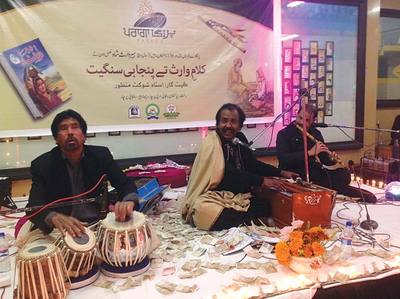 shaukat manzoor in the centre ijaz hussain jajji on tabla and jawad ahmed flute perform at the event photo express