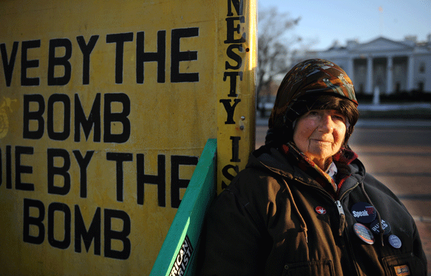 concepcion picciotto posing with her signs across the street from the white house on march 4 2009 in washington dc photo afp