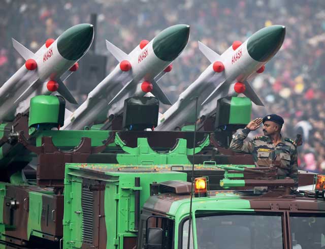 an indian soldier salutes as he rides an akash weapon system of air defence during india 039 s republic day parade in new delhi on january 26 2016 photo afp
