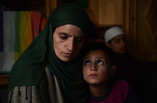 this photo taken on december 22 2015 shows hassina and her son at home in dardpora a himalayan village on the indian side of the de facto border that divides kashmir between india and pakistan hassina 039 s husband former rebel ali mohammad went missing along the border last autumn photo afp