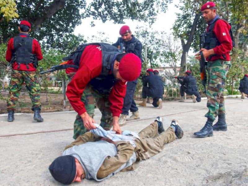 man pins down a suspect as part of a drill at elizabeth school in the city photo muhammad iqbal express