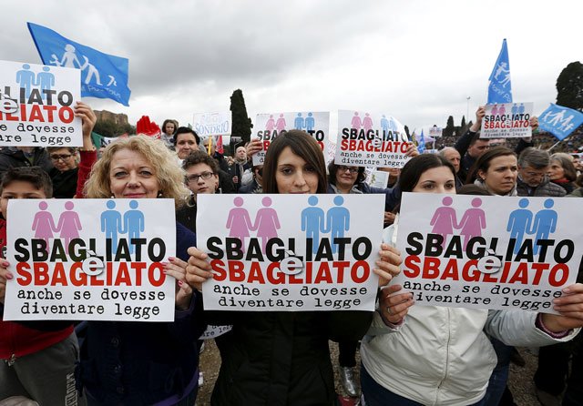 protesters hold signs reading quot it is wrong even if it becomes law quot during a rally against same sex unions and gay adoption in rome italy january 30 2016 photo reuters