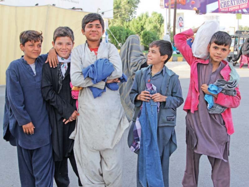 street children were happy to grab an assortment of clothes from wall of kindness at sea view on saturday the adults preferred to take home bags of ration photo aysha saleem express