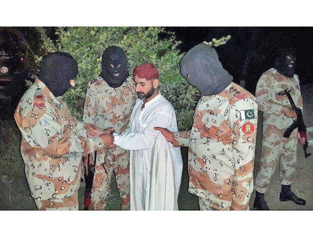 rangers handcuff uzair baloch after his arrest near karachi photo app rangers handcuff uzair baloch after his arrest near karachi photo app