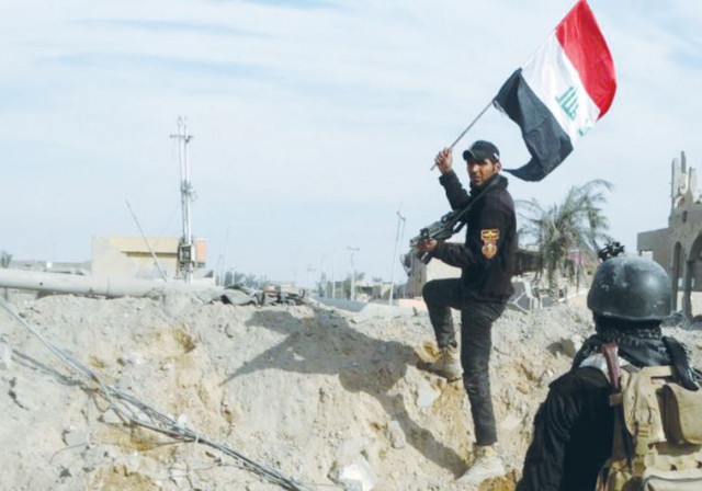 a member of iraq 039 s security forces holds an iraqi flag in ramadi photo reuters a member of iraq 039 s security forces holds an iraqi flag in ramadi photo reuters