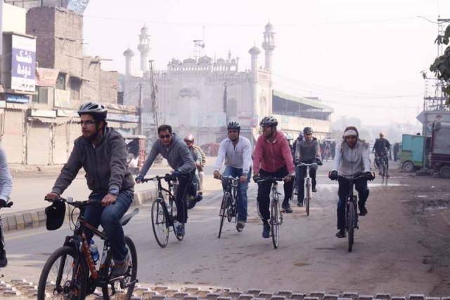 cyclists head towards the shah alam market top left the entrance of the tomb above a view of the minarets and dome right photo amel ghani express