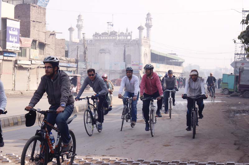 cyclists head towards the shah alam market top left the entrance of the tomb above a view of the minarets and dome right photo amel ghani express