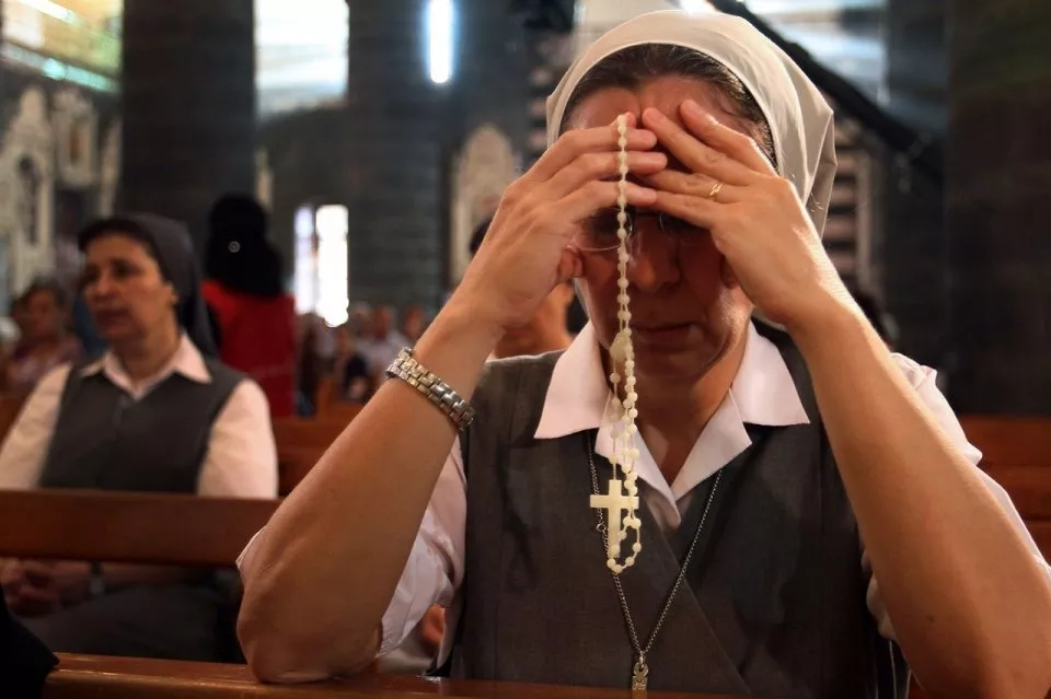 a nun attends a prayer vigil for peace at the lady of dormition the melkite greek catholic patriarchal cathedral in the old city of damascus photo afp a nun attends a prayer vigil for peace at the lady of dormition the melkite greek catholic patriarchal cathedral in the old city of damascus photo afp