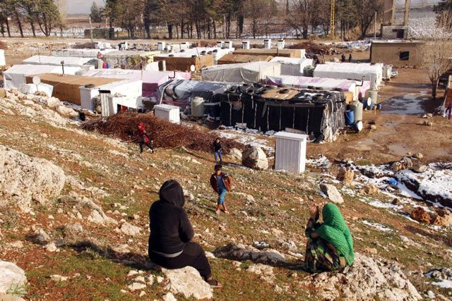 syrian refugees take advantage of the sunshine after a storm at an unofficial refugee camp in bar elias in lebanon 039 s bekaa valley on january 26 2016 photo afp