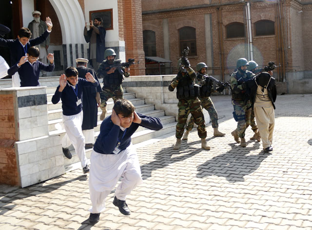 schoolchildren flee as army soldiers conducting an exercise to repel militant attacks detain a mock militant r at the islamia collegiate school in peshawar pakistan february 02 2016 photo reuters