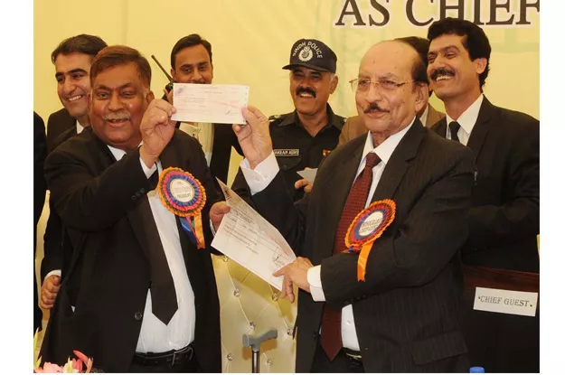 cm sindh giving away a cheque of rs 10 million to kba president photo ppi cm sindh giving away a cheque of rs 10 million to kba president photo ppi