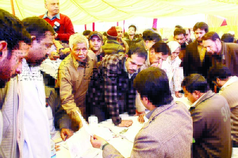 people submit their claims for compensation on wednesday at the one window land acquisition camp set up near the uet photo abid nawaz express