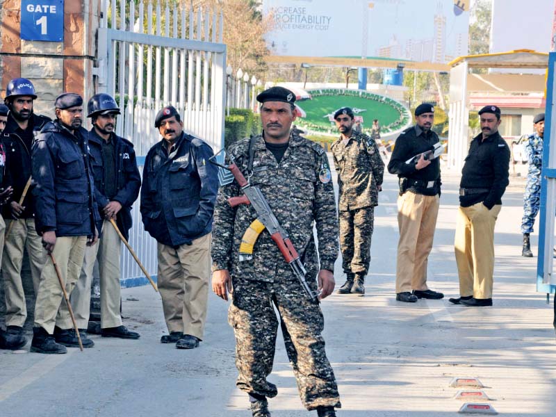 police stand alert outside the rawalpindi airport during a protest by pia employees photo zafar aslam express