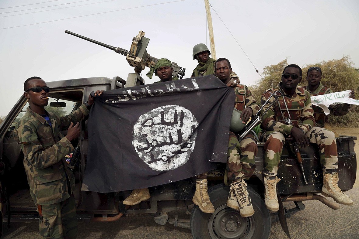 soldiers from niger hold up a boko haram flag that they seized in the town of damasak nigeria photo reuters