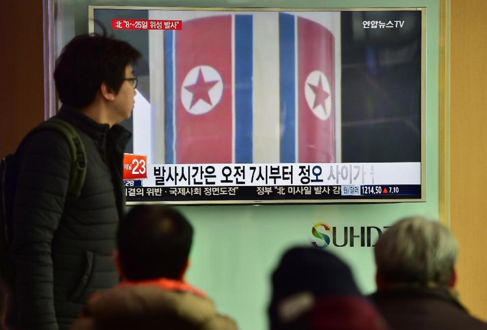 people watch a news report on north korea 039 s planned rocket launch as file footage from north korea 039 s 2012 launch of the unha 3 rocket plays on a tv screen at a railway station in seoul on february 3 2016 photo afp