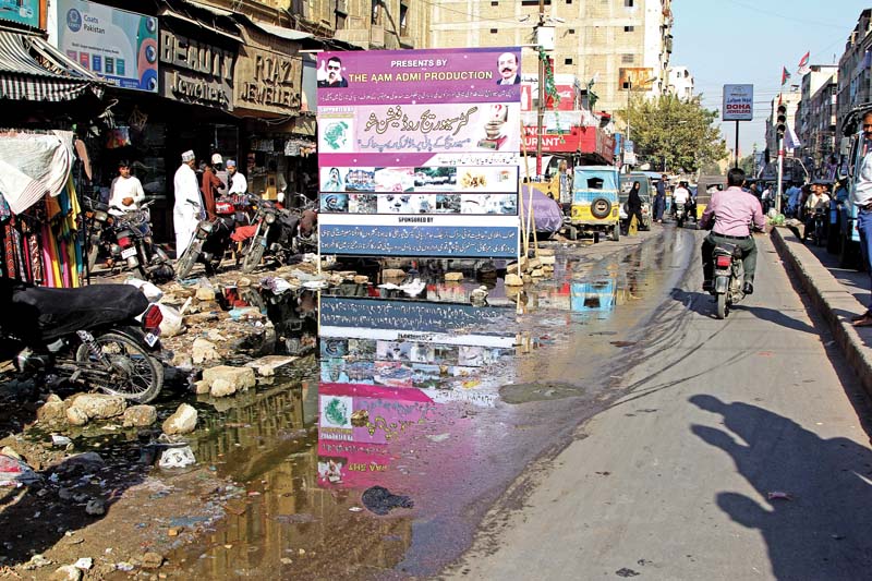 bohri bazaar traders held a mock fashion show in the overflowing gutters outside the market hoping they can shame the government into taking action photo aysha saleem express