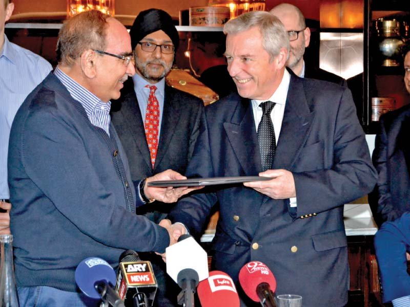 bahria town chief malik riaz and harley street clinic s dr richard gullen exchange documents after signing the agreement photo pr