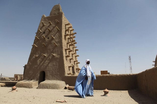 a man stands in front of the djingareyber mosque on february 4 2016 in timbuktu photo afp