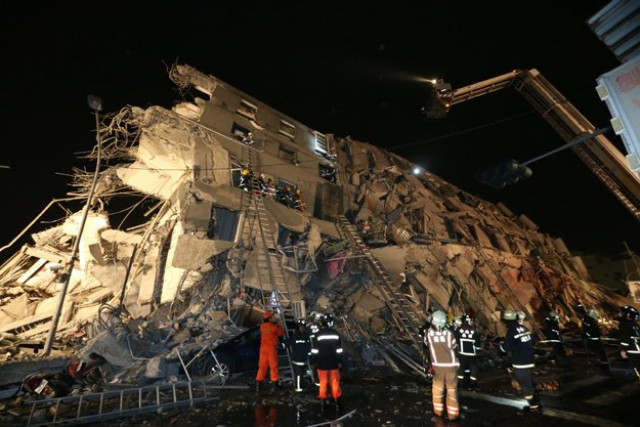 rescuers are seen entering an office building that collapsed on its side from an early morning earthquake in tainan southern taiwan on feb 6 2016 photo afp rescuers are seen entering an office building that collapsed on its side from an early morning earthquake in tainan southern taiwan on feb 6 2016 photo afp