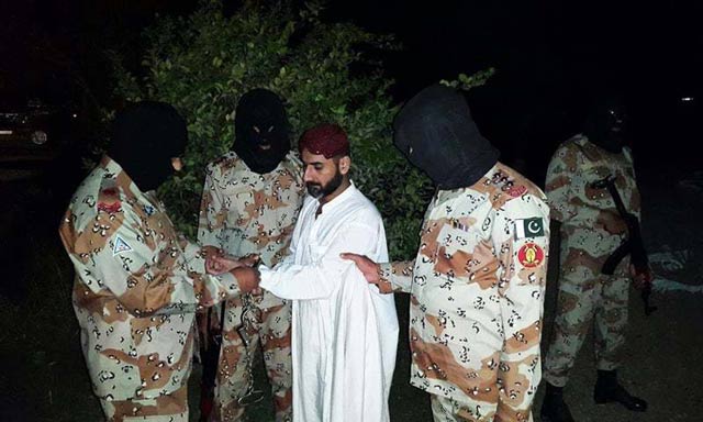 photo released by rangers shows uzair baloch being handcuffed by the paramilitary force photo pakistan rangers