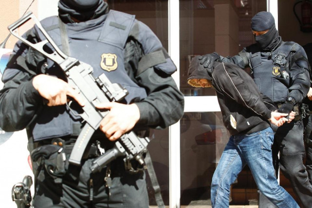 a man suspected of links to islamic state groups is arrested during an anti extremist police operation in sabadell on april 8 2015 photo afp a man suspected of links to islamic state groups is arrested during an anti extremist police operation in sabadell on april 8 2015 photo afp