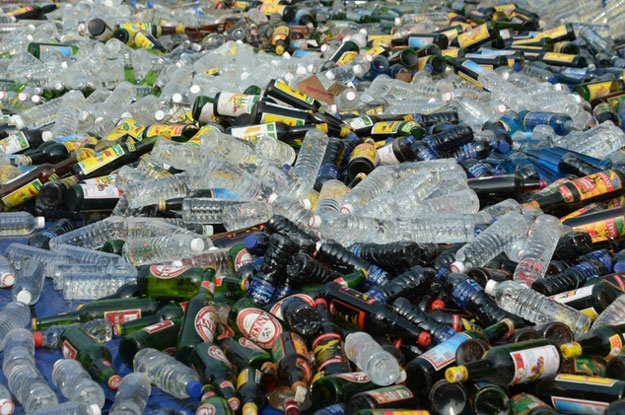 bottles of alcohol sit spread out before being destroyed by authorities ahead of the holy month of ramadan at a police station in jakarta photo afp