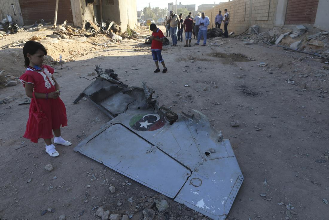 a libyan girl stands next to the wreckage of a government mig warplane that crashed during clashes in benghazi libya on july 29 2014 photo reuters