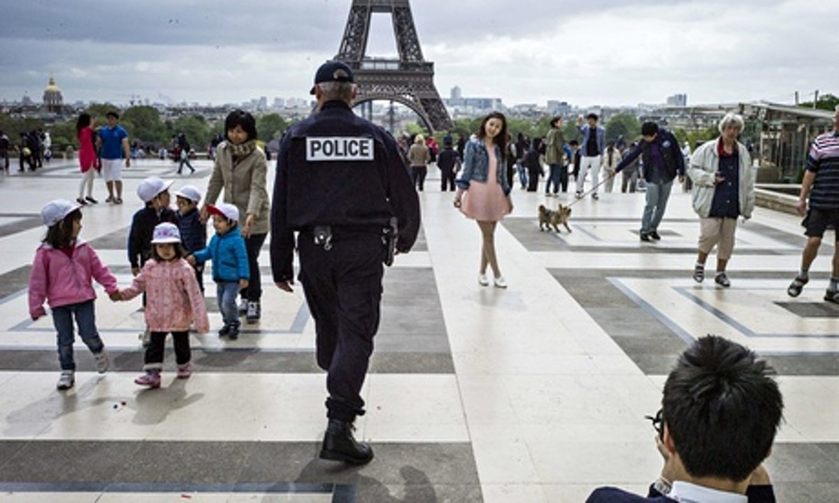 a french police officer patrols on trocadero square in front of the eiffel tower photo afp